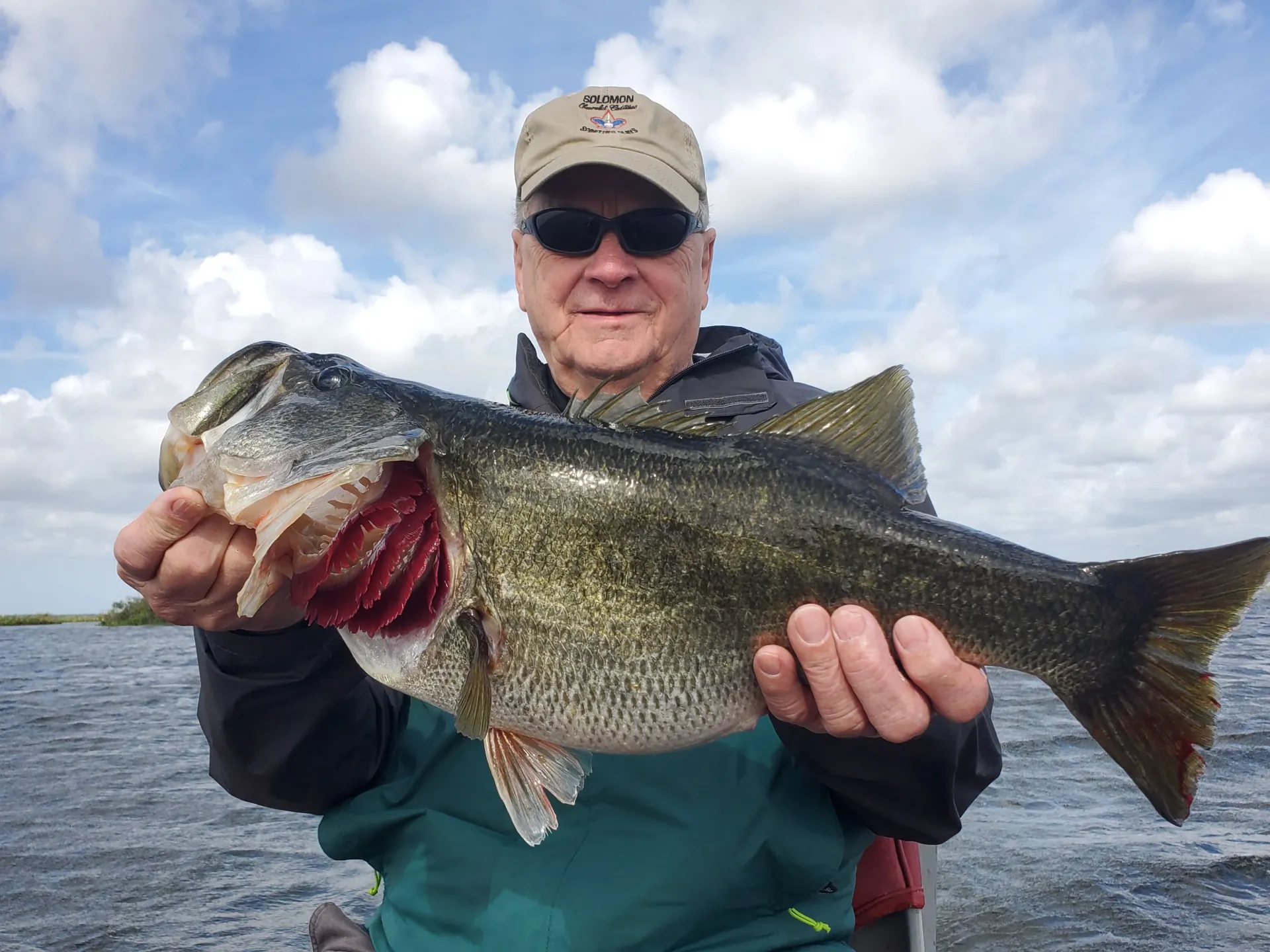 A heavy largemouth under big Florida clouds