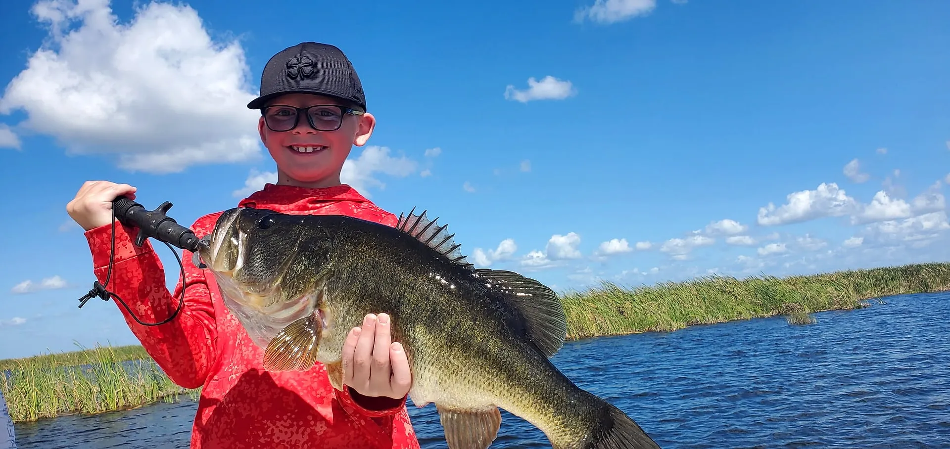 A young angler with an Okeechobee largemouth